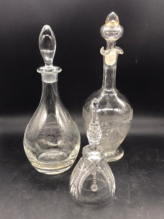 Two glass decanters and a glass bell