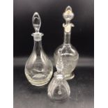 Two glass decanters and a glass bell