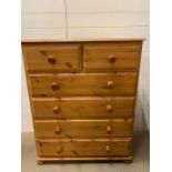 A pine two over four chest of drawers on bun feet (H112cm W90cm D44cm)