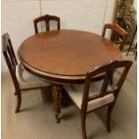A dining table with turned legs and brass castors with four dining chairs and three leaf's (H74cm