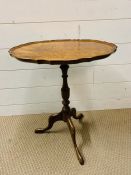 A George III Style tripod table with piecrust top on turned column with down swept legs (H52cm W45cm