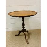 A George III Style tripod table with piecrust top on turned column with down swept legs (H52cm W45cm