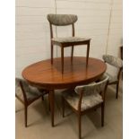 A Mid Century dining table and four chairs, possibly G-Plan fresco teak