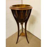 An Edwardian Mahogany Jardinière with open slatted sides and brass liner, splayed trifoiled