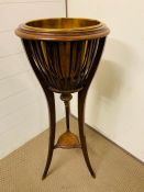 An Edwardian Mahogany Jardinière with open slatted sides and brass liner, splayed trifoiled