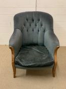 A button back lounge chair in teal