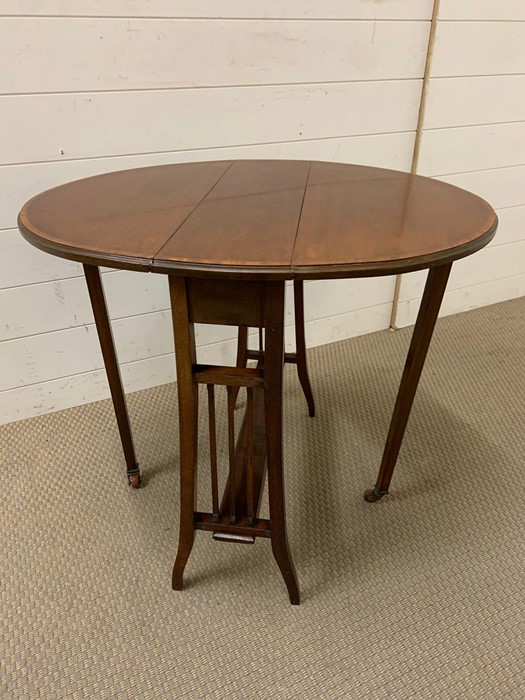 A Sutherland Mahogany table with drop sides (H172cm W72cm D60cm)