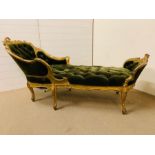 A Gilt wood daybed with foliate carved crest rail and shaped deep buttoned upholstery (H 92 cm x L