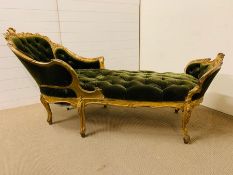 A Gilt wood daybed with foliate carved crest rail and shaped deep buttoned upholstery (H 92 cm x L