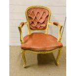 A French painted open armchair with upholstered back, arm and seat on cabriole legs.