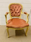 A French painted open armchair with upholstered back, arm and seat on cabriole legs.