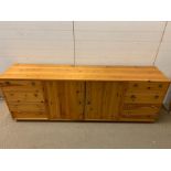 A pine sideboard (214 cm wide by 45 cm deep x 77 cm high)