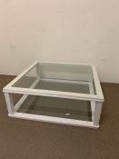 A glass coffee table in a white painted wooden frame (H35cm 92cmsq)