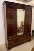 A Maple & Co Double wardrobe with a righthand door opening to reveal shelves with two drawers