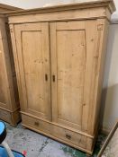 A two door pine wardrobe with two drawers under (H185cm W128cm D60cm)