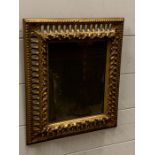 A gilt framed foxed wall mirror (37cm x 32cm)