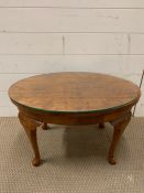 A small burr walnut oval side table (H39cm W64cm D44cm)