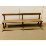 A Victorian pine school pew (H64cm W190cm D63cm)