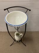 A wrought iron wash stand with bowl and jug