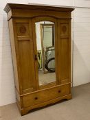 A wardrobe or coat cupboard with mirrored front panel door and drawer to base (H207cm W134cm D54cm)