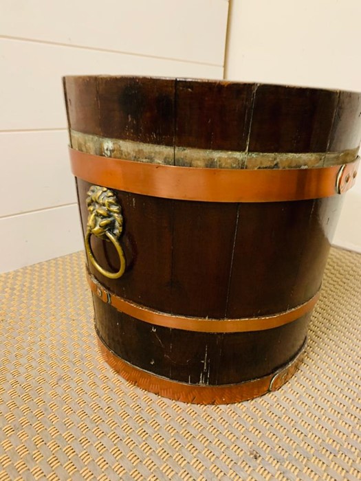 A George III Style mahogany and brass bound peat bucket (30 cm H)