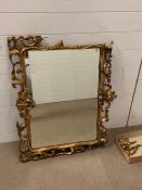 A giltwood wall mirror with rectangular plate and openwork scroll frame AF (75cm x 90cm)