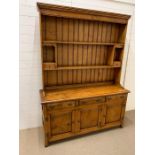 An Stewart Linford burr oak dresser with plate rack and cupboard under(H200cm W148cm D47cm)