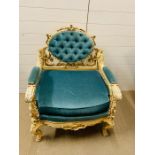 A Louis XV Style armchair/throne. The chair frame is decorated with foliate and scroll carving,