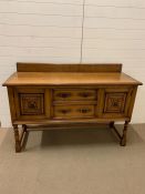 A burr oak sideboard with drawers and cupboard under with wrought iron handles (H108cm W152cm