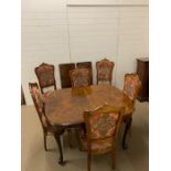 An extending dining table with moulded top on pad feet, two leaves and six upholstered chairs (Table