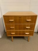 A Mid Century oak and teak chest of drawers by Hunt on tapering feet (H86cm W76cm D47cm)