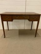 A mahogany desk with drawer to centre and flanked each side with a further drawer on ball and claw