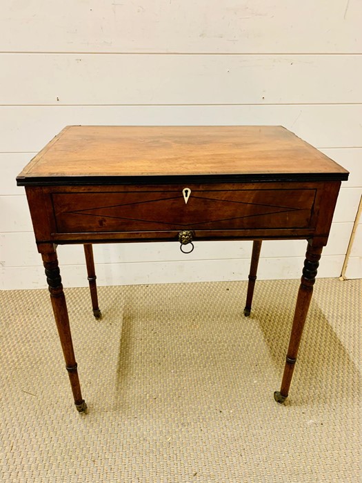 A Regency Ladies work box with concealed drawer, ebony lined. (H59cm W53cm D37cm)