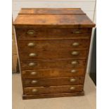 A pine seven drawer Clarks desk with brass shell style handles (H115cm W85cm D54cm)