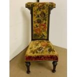 A Victorian Ebonised Prie Dieu chair, the back and seat upholstered with tapestry.