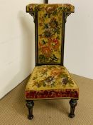 A Victorian Ebonised Prie Dieu chair, the back and seat upholstered with tapestry.