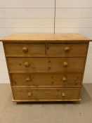 A Two over Three pine chest of drawers on bun feet ( 95 cm w x 48 cm d x 91 cm h)