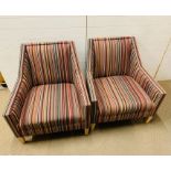 A pair of contemporary armchairs with striped upholstery