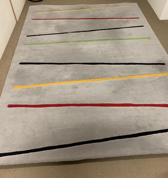 A grey thick pile rug, with strips of colour (300cm x 225cm)