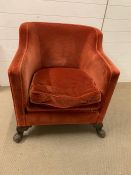 A red velvet club chair with long base seat