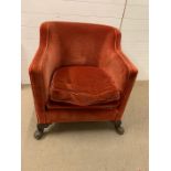 A red velvet club chair with long base seat