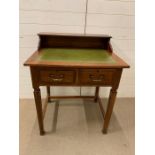 A small writing desk with green leather top and two drawers (H91cm W77cm D60cm)