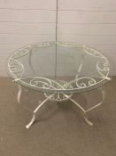 A wrought iron, glass topped table (91 cm Diameter x 54 cm high)