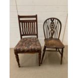 One oak wheelback chair and one oak dining chair