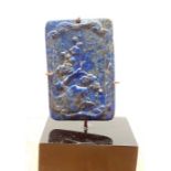 A Chinese lapis lazuli in form of a tablet, carved in shallow relief with a landscape, pierced for