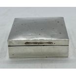 A Silver cigarette box with indistinct hallmarks, 9 x 9 cm sq and 3 cm high.