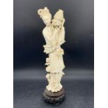 A carved Japanese lady on stand