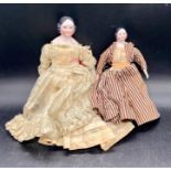 Two Victorian dolls with china heads, arms and legs.