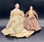 Two Victorian dolls with china heads, arms and legs.