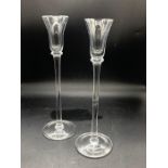 A pair of wine glasses with bell bowl raised on a long stem and plain foot (H: 30 cm). (2)